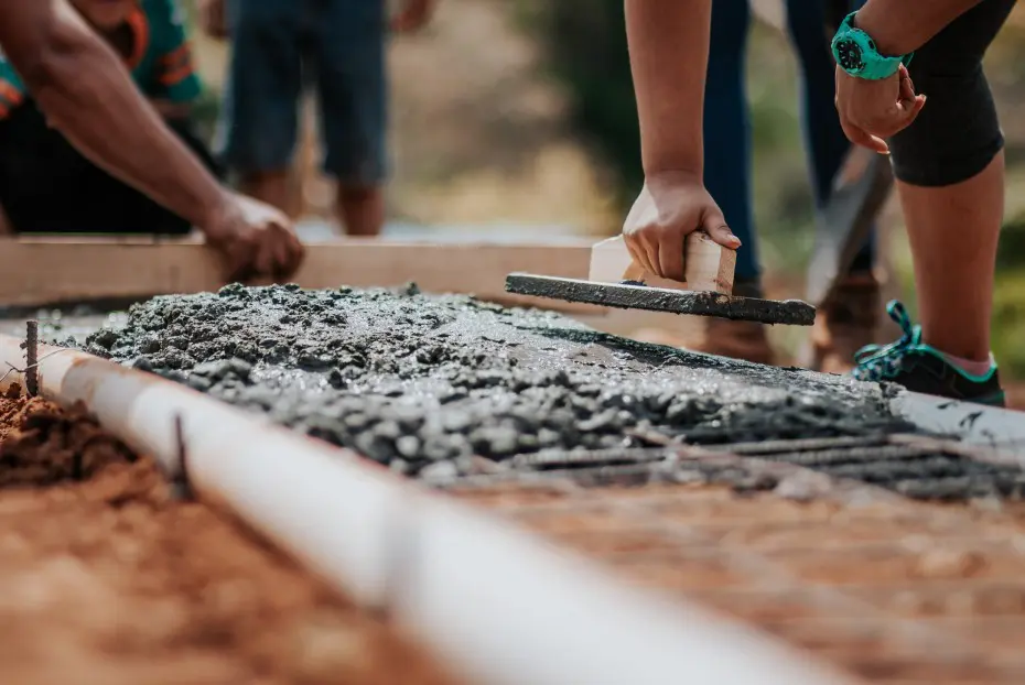 Worker adjusting concrete