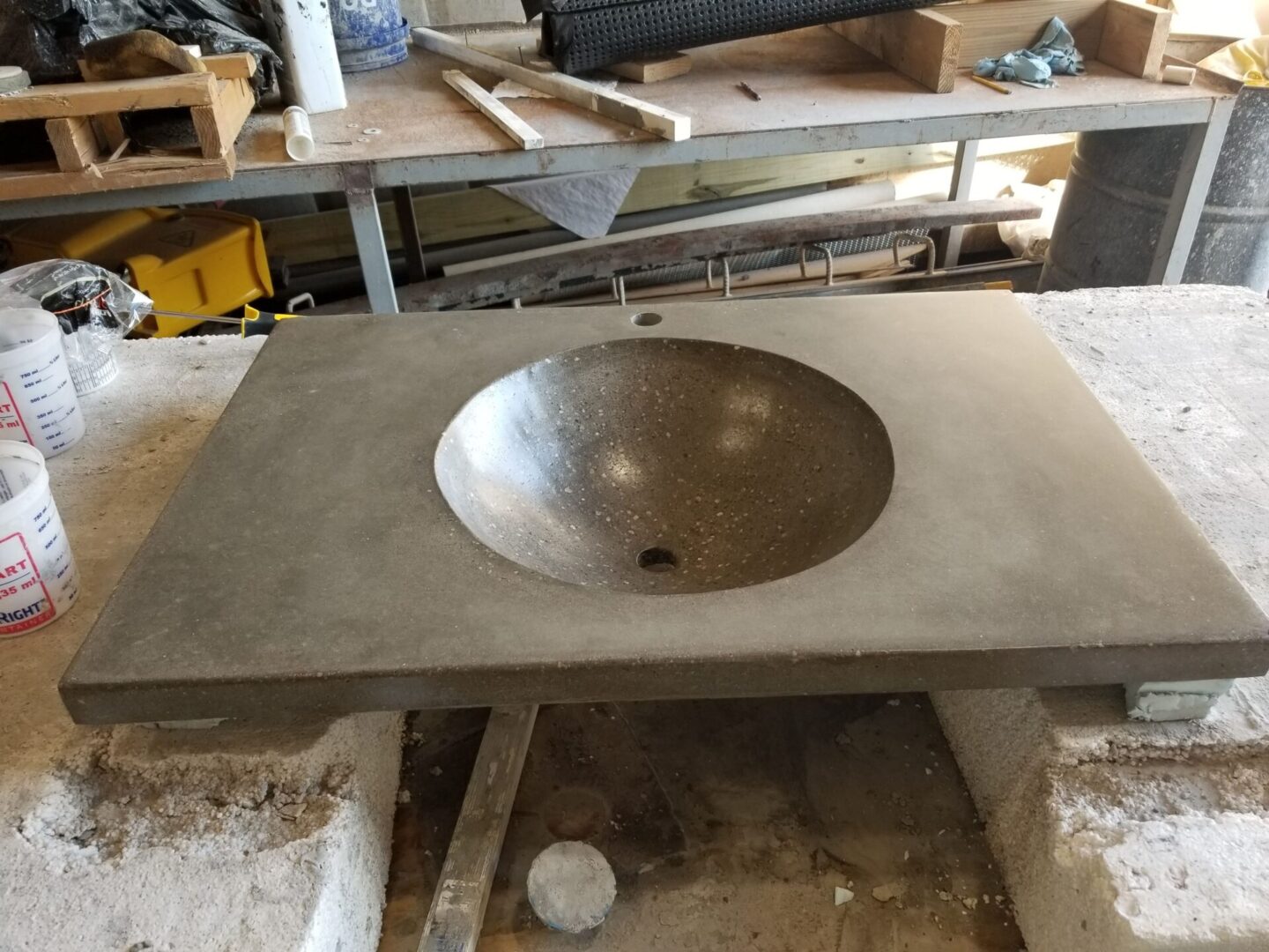 A concrete sink countertop on a workstation