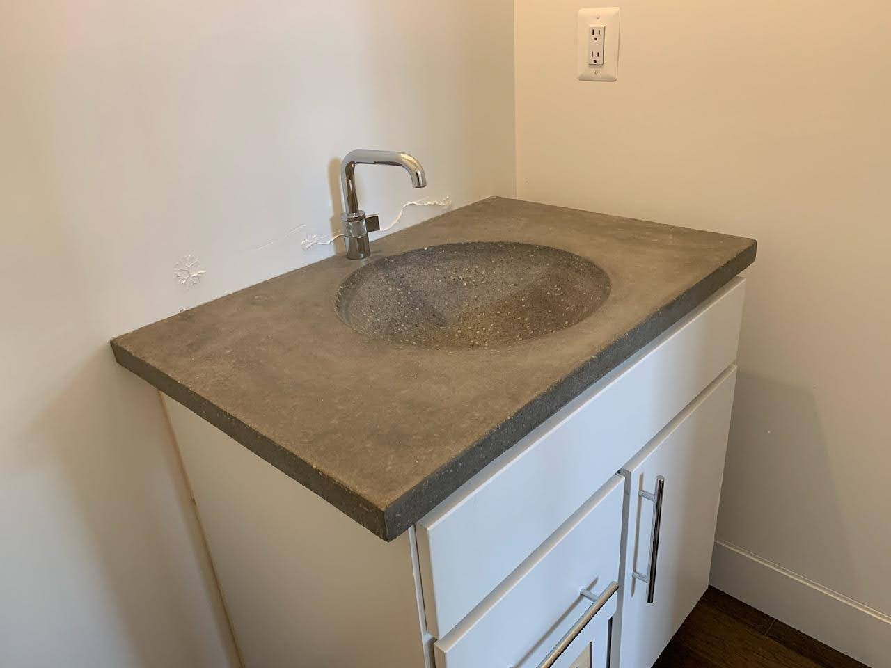 A sink with a concrete surface